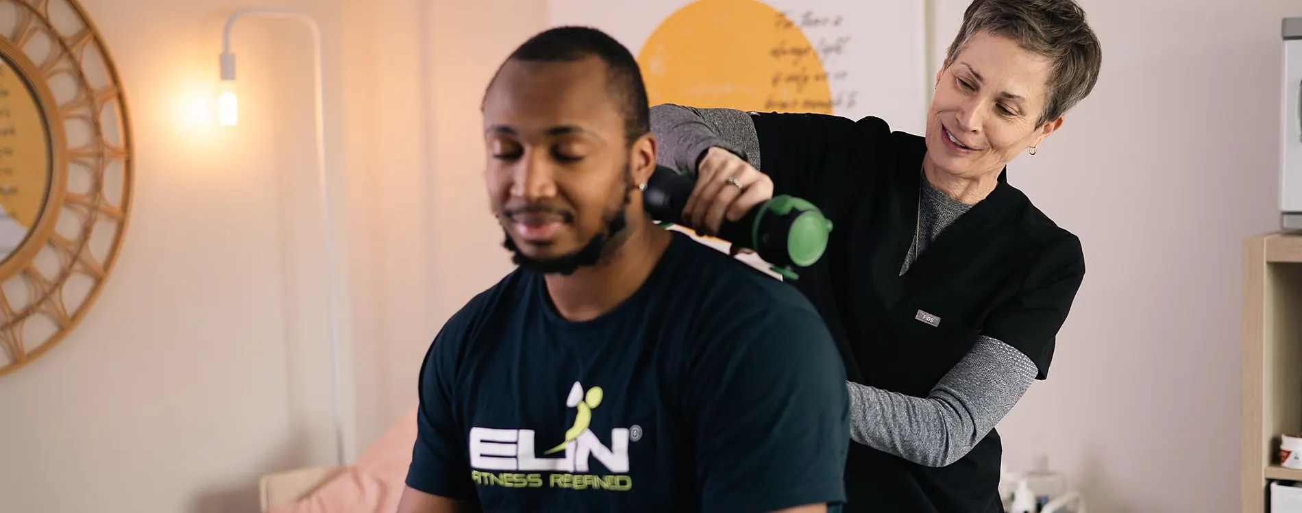 Dana treating an athlete's shoulder in her Bethesda treatment room